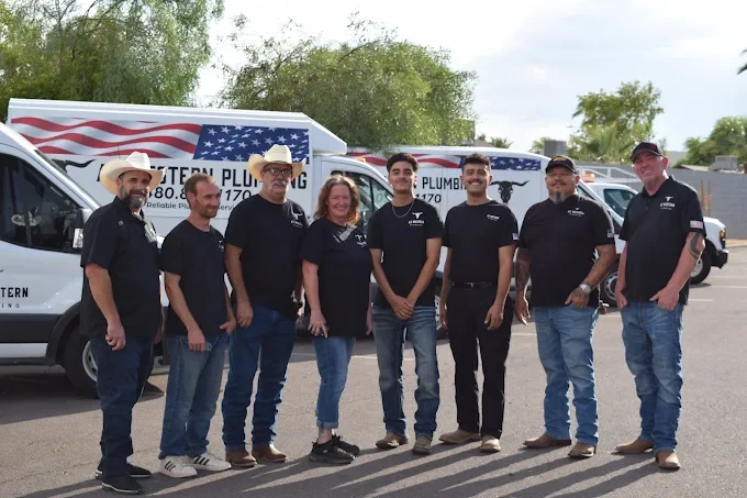 AZ Western Plumbing & Air team together in front of their company vehicles