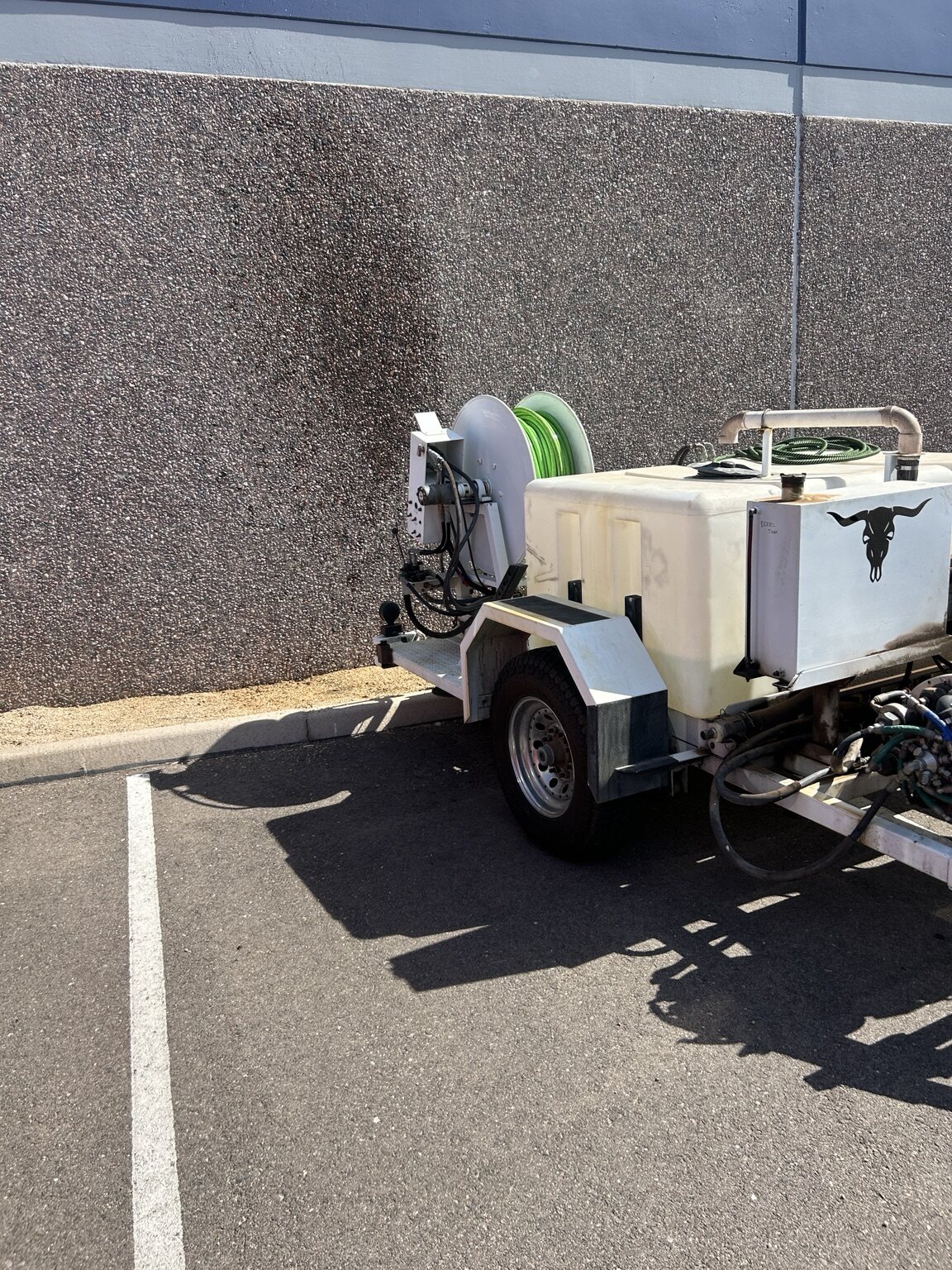 AZ Western trailer with tank and hose reel parked outside