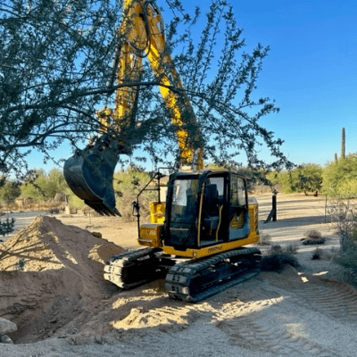 Excavator working on a dirt site in the Arizona desert
