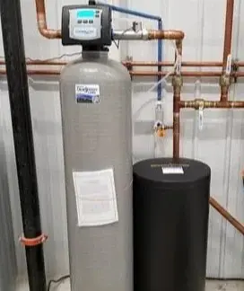 Installed water softener and treatment tanks with copper pipes